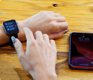 A woman connecting her phone text messages to her Life Watch.