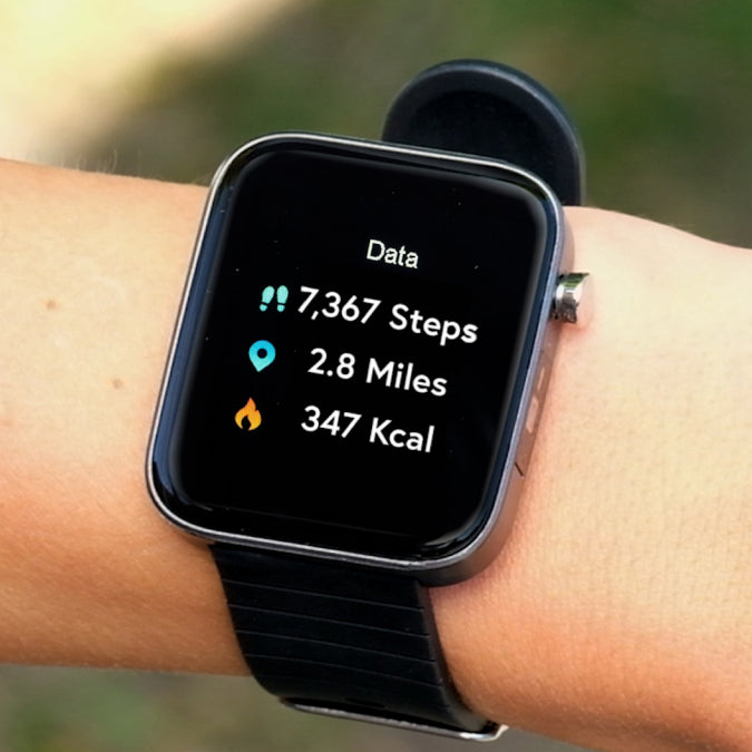 A close up of a Life Watch on someone's wrist displaying: steps, miles and Kcals.